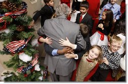 President George W. Bush is smothered in little hands as he says goodbye to a group of children in attendance Monday, Dec. 8, 2008, for the Children's Holiday Reception and Performance at the White House. The President and Mrs. Laura Bush traditionally invite children to a White House celebration for the holidays, and this year, the audience included kids of active duty and reserve military service members from Russell Elementary at Quantico Marine Base, Dahlgren School at Dahlgren Navy Base and West Meade Elementary at Ft. Meade Army Base.  White House photo by Eric Draper