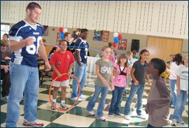 Football players from Fairmont High School joined in physical fitness activities with the third graders of Greenmont Elementary School. 