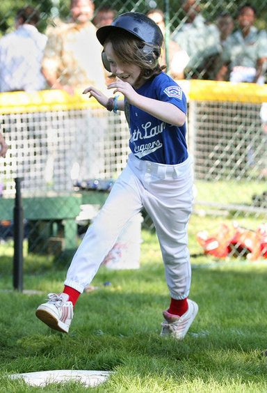 Stars player Bridget Donahue of Westborough, Mass., leaps for home plate during action in the Tee Ball on the South Lawn: A Salute to the Troops game Sunday, Sept. 7, 2008 at the White House, played by the children of active-duty military personnel. White House photo by Joyce N. Boghosian