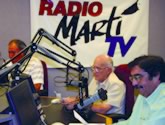 Broadcasters read the news in an OCB studio in Miami.