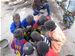 Photo of children eating rice for lunch out of a bowl outside a local health post. (click here to see more)