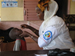 Photo of a child receiving vitamin A from a health worker. (click here to see more)