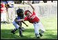 The Stars catcher reaches to tag out a Stripes player during home plate action at the Tee Ball on the South Lawn: A Salute to the Troops game Sunday, Sept. 7, 2008 at the White House, played by the children of active-duty military personnel. White House photo by Chris Greenberg