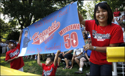  Tee Ball All-Star Joshua Miyazawa, age 5, gets a boost from his Hawaiian fan club as he plays on the South Lawn of the White House on July 16, 2008. The banner also holds a greeting for President George W. Bush, who watched the demonstration of teamwork and discipline from a nearby bleachers with Mrs. Laura Bush and the families of the children attending. One child represented each state and the District of Columbia and the teams were divided into Western, Central, Southern and Eastern teams, with Joshua playing on the Western Team.
