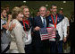 President George W. Bush and Mrs. Laura Bush pose for photos with U.S. Olympic swimmers Larsen Jensen, left, and Michael Phelps Sunday, Aug. 10, 2008, at the National Aquatics Center in Beijing. White House photo by Shealah Craighead