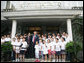 Standing with the Kuanjie Summer Vacation School Choir and Pastor Meng Maoru, President George W. Bush delivers a statement outside Beijing Kuanjie Protestant Christian Church in Beijing Sunday, Aug. 10, 2008. Said the President, "Laura and I just had the great joy and privilege of worshiping here in Beijing, China. You know, it just goes to show that God is universal, and God is love, and no state, man or woman should fear the influence of loving religion." White House photo by Chris Greenberg