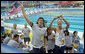 U.S. athletes wave to President George W. Bush and Mrs. Laura Bush after their arrival Sunday, Aug. 10, 2008, to the National Aquatics Center in Beijing, where they viewed the morning session of the swimming competition at the 2008 Summer Olympics. White House photo by Shealah Craighead