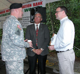 Seattle District Commander Col. Anthony Wright discusses mitigation banking with Snohomish County Airport Director Dave Waggoner and Pete Mills, of Congressman Jay Inslees office. (Photo by Pamela Graesser)