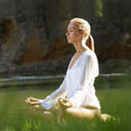 Woman meditating by stream. Copyright Getty Images