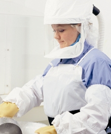 woman wearing powered, air-purifying respirator with loose-fitting hood