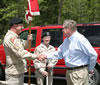 Congressman Marion Berry greets two members of the 39th Infantry Brigade (Separate), Arkansas Army National Guard, Friday before the Dam Site Park ribbon cutting ceremony.  Sgt. Steven Cook, left, and Spec. Tiffany Anderson were among five members from the 39th who served as color guard at the ceremony.  (Army Corps of Engineers photo.)