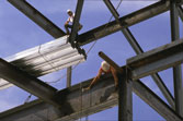 Construction workers connecting steel beams