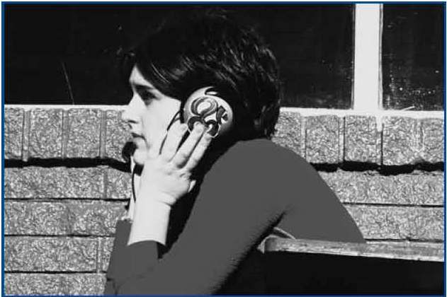 Photograph of young person taling on the telephone.