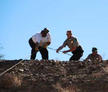 A team of volunteers put their backs into the task of pulling the loaded game carts to the top of the ravine