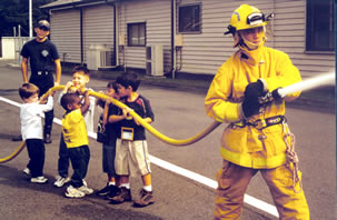 Students helping hold fire hose.