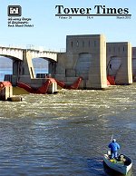 March Tower Times cover.  Major rehabilitation at Lock and Dam 12 didn't keep this fisherman from casting for a big catch below the dam during a brisk, but sunny, Dec. 17 morning.  Photo by Mark Kane.