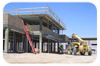 Contractors build up the outer walls of the simulated Iraqi village located on Fort Irwin, Calif. during construction efforts in August. Construction began in February and is scheduled to be complete in February 2008. The village was designed and has been built to Iraqi standards with the exception of the supports which were built to withstand the seismic activity in the area.