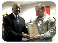 Rev. Rethis Murry receives an award from COL Alex Dornstauder