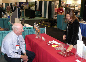 Bill Veith, U.S. Army Engineering and Support Center, Huntsville, discusses the U.S. Army Corps of Engineers' Military Munitions Support Services with Helene Y. Takemoto, USACE Honolulu District, at the Joint Services Environmental Management conference.  (Photo by Chris Gardner)