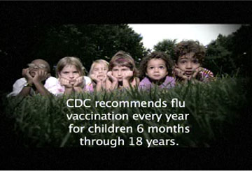 A photo of children laying in a grass field.