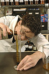 Herbalist compounding (preparing) an herbal extract. © Bob Stockfield