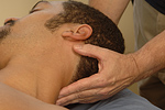 Massage therapist  manipulating the head and neck during a massage  session. © Bob Stockfield