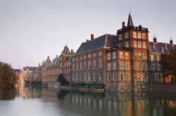 European building on water at sunset