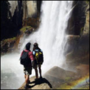 Photo: Two hikers at a waterfall