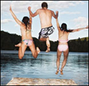 Photo: Three kids jumping off of a dock