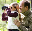Photo: A father and daughter bird watching