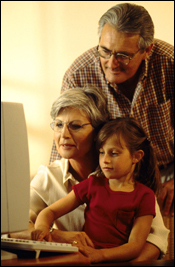 Photo: A family gathered around a computer