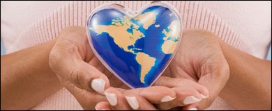 Photo: Hands holding a heart-shaped globe