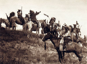 Several Indians in war costumes on horses
