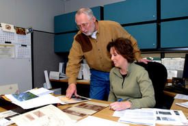 Owen Dutt and Deanne Strauser look over paperwork for the transfer of river navigator duties.  (Photo by Russell Elliott)