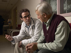 Young doctor and older gentleman in waiting room