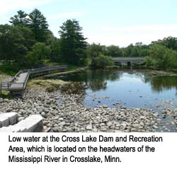 Photo of a dam with very little water behind it.