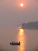 Sunrise with boat on the lake