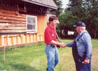 A Corps' employee shakes hand with a flood victim