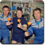 IMAGE: Expedition One crew prepares to eat fresh fruit.
