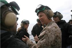 Colonel Mark J. Desens, commanding officer of the 26th MEU, talks to distinguished guests with the JOC