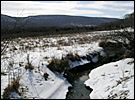 Snow in the fields along a stream at Cherry Valley National Wildlife Refuge.