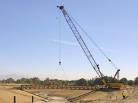 A crane lowers a 145-foot steel bridge into place at the Bull Creek Restoration Project Dec. 9. The bridge is one of four new pedestrian bridges included in the project. (USACE photo by Danny Kelly)