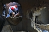 U.S. Marine Corps Sgt. Chaaka Dais works through the maze of concrete, metal and wood in search of mock survivors in a simulated building collapse during basic course training at the Chemical, Biological Incident Response Force based at Indian Head, Md., Dec. 18, 2008.