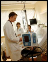 Photo of 2 pharmacists talking with a patient.