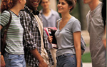 Photograph of youth talking and smiling.