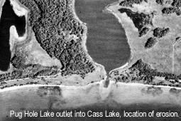 Aerial black and white photo of a lake outlet.