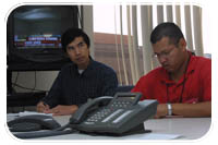 (Left to right) Army Corps of Engineers housing group team members Robert Kwan and Delvin Rivas take notes during a teleconference Oct. 25 at the Joint Field Office in Pasadena. The team, as part of a combined federal team including FEMA, is preparing to assist victims of the recent wildfires that forced more than half a million people out of their homes.