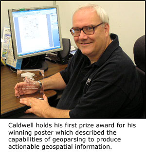 Caldwell holds his first prize award for his winning poster