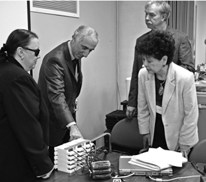 Michael Katzmann demonstrates the talking-book flash-cartridge duplication system to Kim Charlson, American Council of the Blind; Keiko "Kay" Holloman, Keystone Systems, Inc.; and Robert Maier, Massachusetts Board of Library Commissioners.