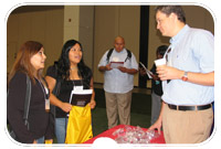 Leticia Reyes (left) and Chantel Atcitty of Estrella Mountain Community College in Arizona speak with Corps recruiter about student intern positions.  Both are currently participating in the Lockheed Apprenticeship Program.